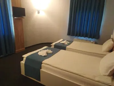 two beds in a hotel room with towels on them at Hotel Fors in Burgas City