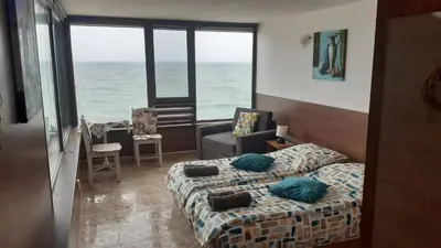 a bedroom with a bed and a view of the ocean at Happy beach in Varna City