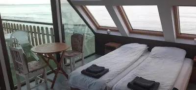 a bedroom with a bed and a table and chairs at Happy beach in Varna City