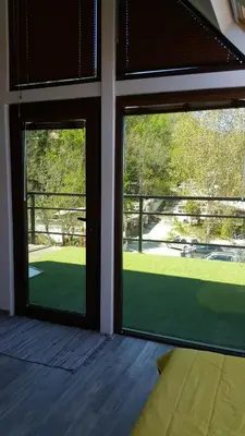 two windows in a room with a view of a yard at Happy beach in Varna City