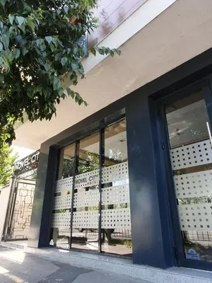 a store front with glass windows with a table in it at Family Hotel Novel City in Burgas City