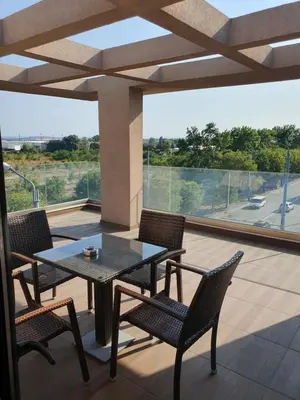 a patio with a table and chairs on a balcony at Family Hotel Novel City in Burgas City