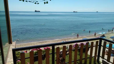 a view of a beach with people in the water at Hemingway rooms in Happy Beach in Varna City