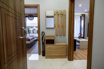 a room with a bathroom with a sink and a door at Sky Garden Apartment Burgas in Burgas City