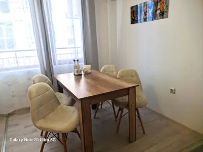 a dining room with a wooden table and chairs at Aglaya 2 in Pomorie