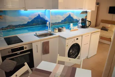 a kitchen with a sink and a washing machine at Aglaya 2 in Pomorie