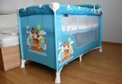 a blue bed with a hello kitty crib in a room at Aglaya 2 in Pomorie