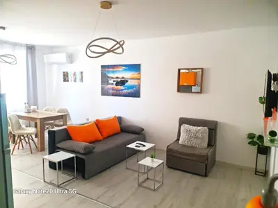 a living room with a couch and a chair at Aglaya 2 in Pomorie