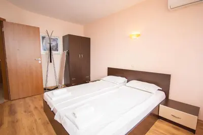 a bedroom with a large white bed in it at Villa Tuna in Sveti Vlas