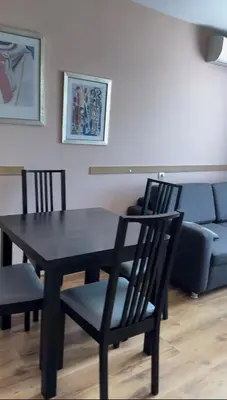 a black dining room table and chairs with a couch at Villa Tuna in Sveti Vlas