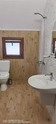 a bathroom with a white sink and a toilet at Джорджия in Kiten