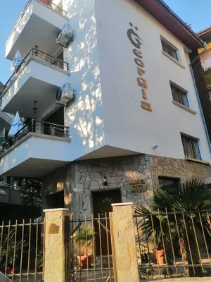 a building with a fence in front of it at Джорджия in Kiten
