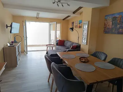 a living room with a table and chairs and a couch at Arte Casa in Burgas City
