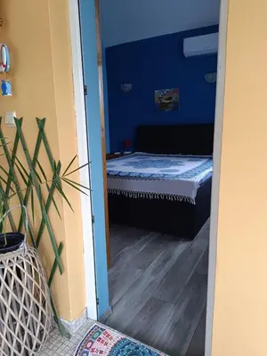 a bedroom with a bed in a blue room at Arte Casa in Burgas City