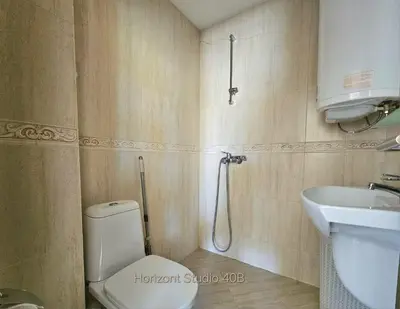 a bathroom with a toilet and a sink at Aпартаменти Хоризонт in Sozopol