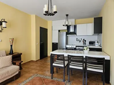 a kitchen with a kitchen island in a room at Aпартаменти Хоризонт in Sozopol