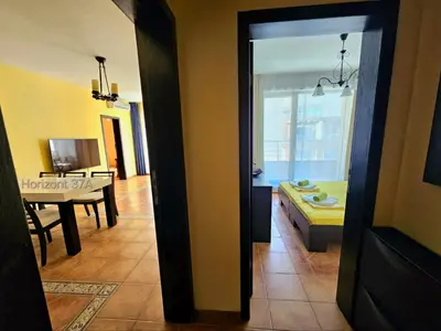 a view of a living room and a dining room at Aпартаменти Хоризонт in Sozopol