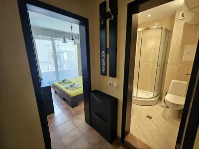 a bathroom with a shower and a toilet and a sink at Aпартаменти Хоризонт in Sozopol