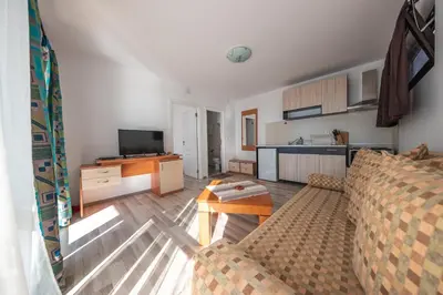 a living room with a couch and a kitchen at Dream View in Byala