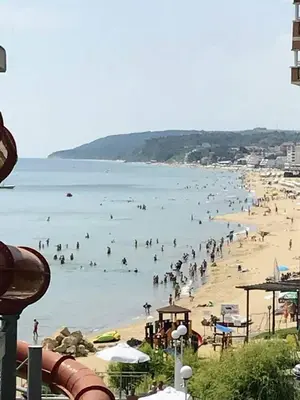 a group of people swimming in the water at a beach at Dream View in Byala