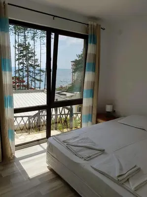 a bedroom with a bed and a view of the ocean at Dream View in Byala
