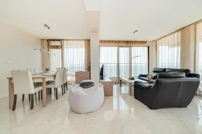 a living room with a couch and a table at Apartcomplex Golden Bay in Ravda