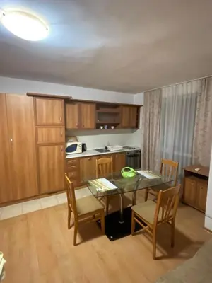 a kitchen with a table and chairs in a room at Levante apartments in Nesebar