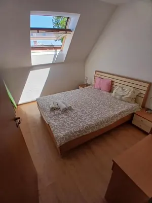 a bedroom with a bed with two shoes on it at Levante apartments in Nesebar