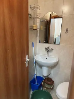 a bathroom with a sink and a toilet and a mirror at Частен апартамент Лагуна - Private Two-Bedroom Apartment Laguna in Primorsko