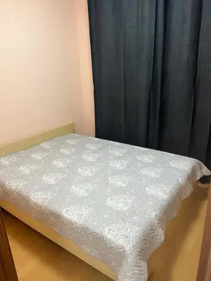 a bed in a room with a black curtain at Частен апартамент Лагуна - Private Two-Bedroom Apartment Laguna in Primorsko