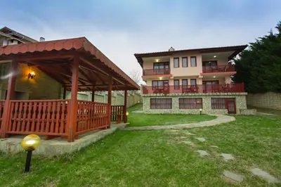 a house with a porch and a gazebo at Holiday Home Paulovnia in Tschenge