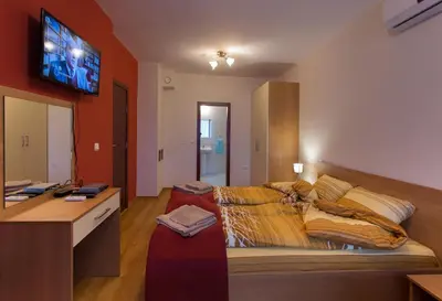 a living room with a couch and a flat screen tv at Holiday Home Paulovnia in Tschenge