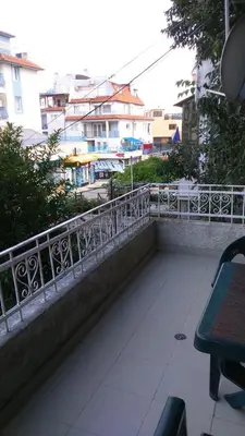 a balcony with a metal railing next to a table at Одеса 37 in Sozopol