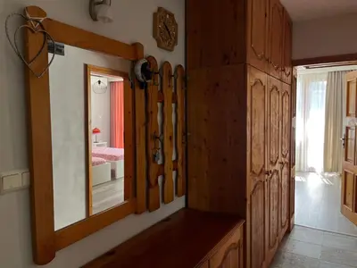 a room with a mirror and some wooden cabinets at Одеса 37 in Sozopol