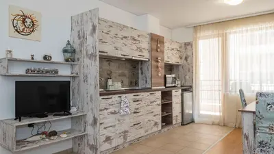a living room with a tv and a wooden wall at Lora boutique in Pomorie