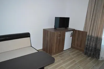 a room with a bed and a tv on a cabinet at SummerHouse Lozenets in Lozenets