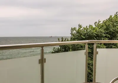 a view of the ocean from the balcony of a house at Family Hotel Albizia Beach in Varna City