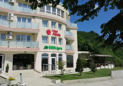 a hotel with a sign on the front of it at Family Hotel Albizia Beach in Varna City