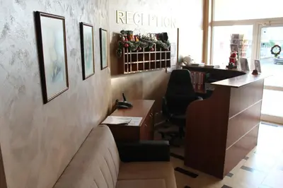 an office with a couch and a desk in a room at Family Hotel Lazuren Briag in Burgas City