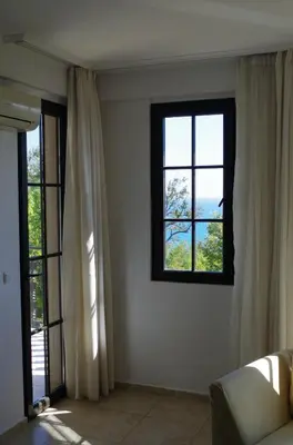 a living room with two windows and a couch at Beautiful 1st-Line Seaview Private Appartement in The Cliff resort in Obzor