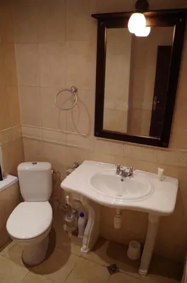 a bathroom with a sink and a toilet and a mirror at Beautiful 1st-Line Seaview Private Appartement in The Cliff resort in Obzor