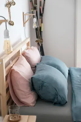 a pile of pillows sitting on a couch with a lamp at Balabanov White in Varna City