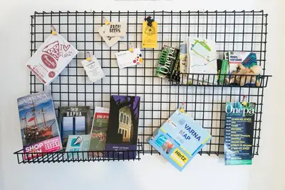 a wire rack with books and other items on it at Balabanov White in Varna City