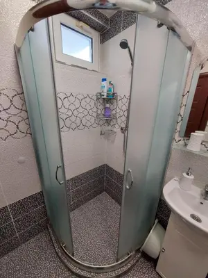 a shower with a glass door in a bathroom at Apartment Larissa in Pomorie