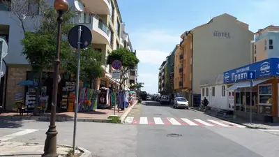 a city street with a crosswalk in a city at Apartment Larissa in Pomorie