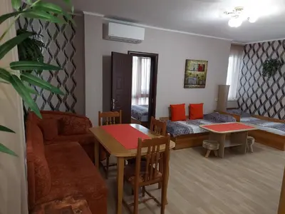 a living room with a couch and a bed and a table at Apartment Larissa in Pomorie
