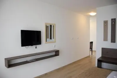 a living room with a flat screen tv on a white wall at studio ASI in Obzor