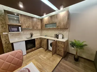 a kitchen with wooden cabinets and a sink and a dishwasher at MitProt Panorama Bay 2 luks Apartment ap100 in Sveti Vlas