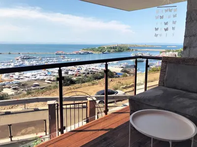a balcony with a couch and a view of the ocean at Villa Victoria - a luxury appartment with icredible Seaview in Sozopol