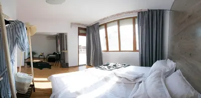 a bedroom with a white bed and a large window at Cherry Garden Apartments in Sveti Vlas